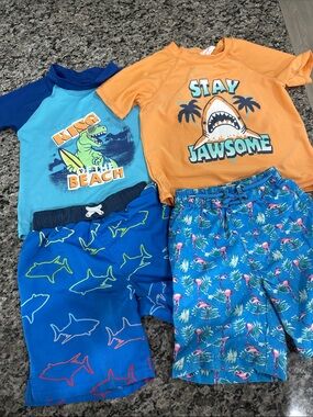 2 Swim trunks and 2 Rash guards gently used size 4T